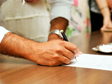 Person writing with a pen