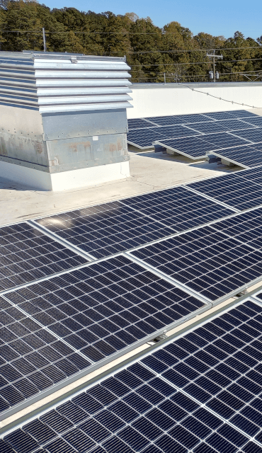 Solar panels on a white flat roof.