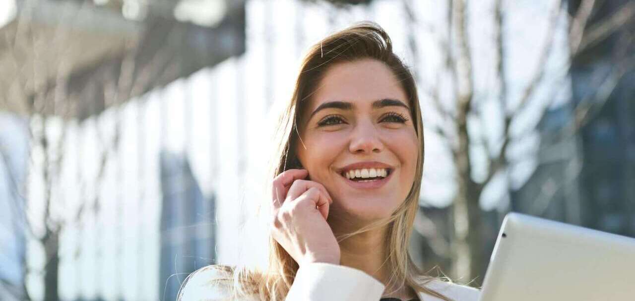 Women smiling and talking on a phone