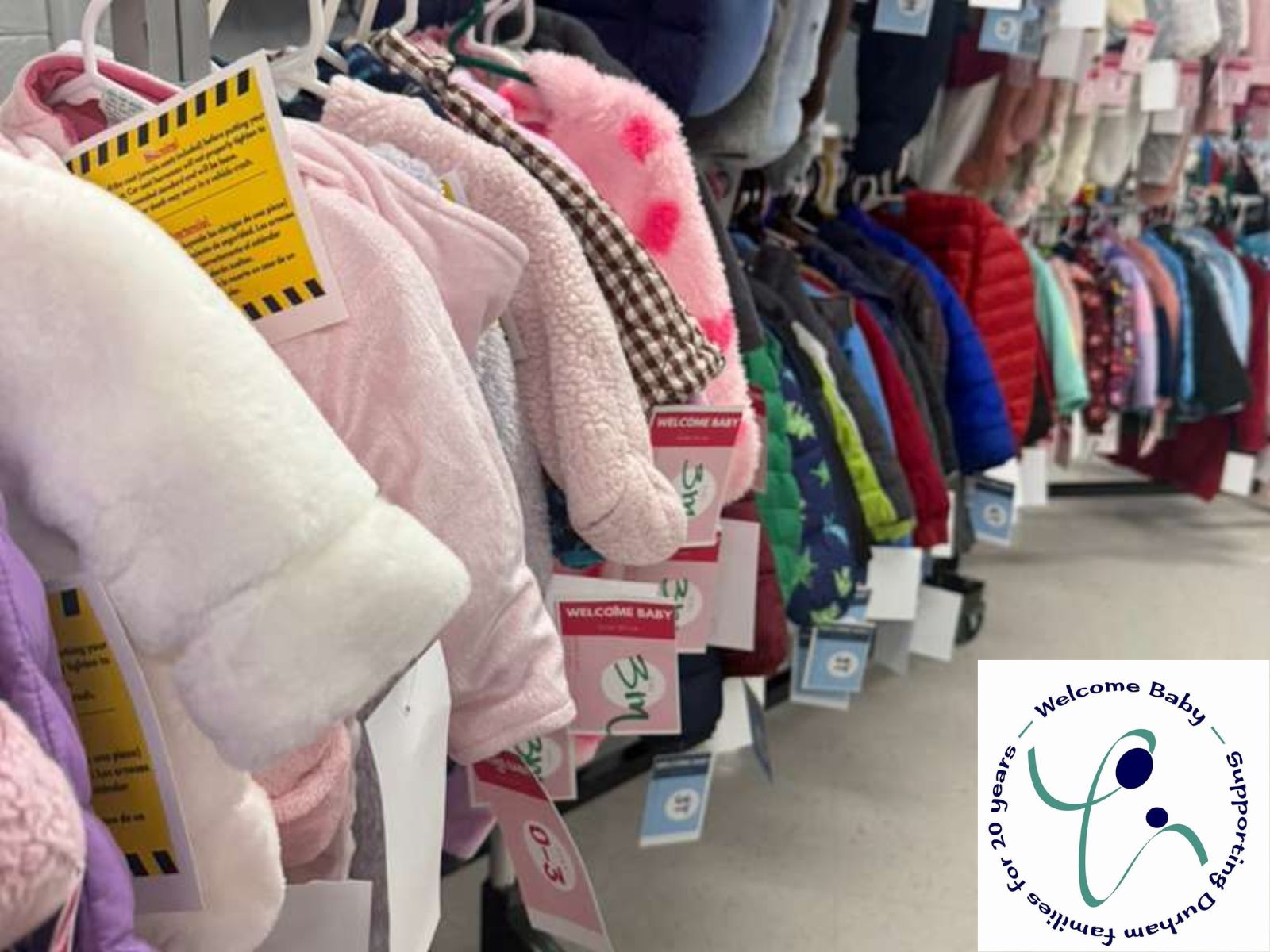 Coats on racks inside the Welcome Baby offices.