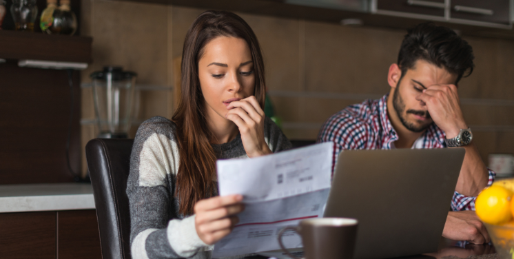 couple with laptop and bills