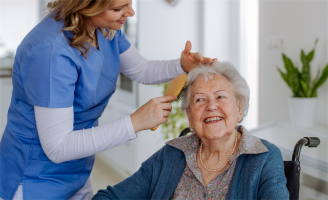 aide combing elderly woman's hair